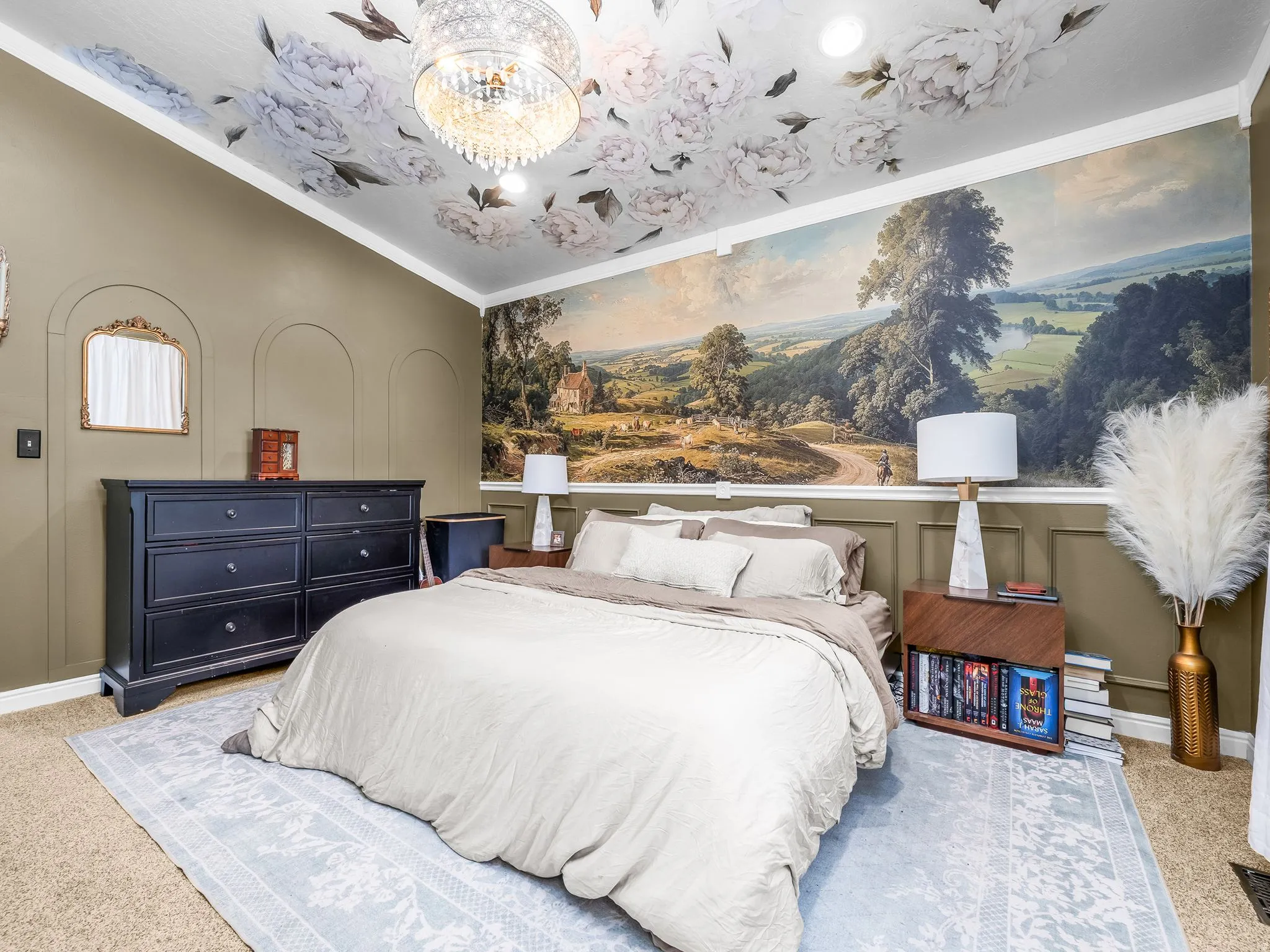 Floral-patterned ceiling with a crystal chandelier and recessed lighting