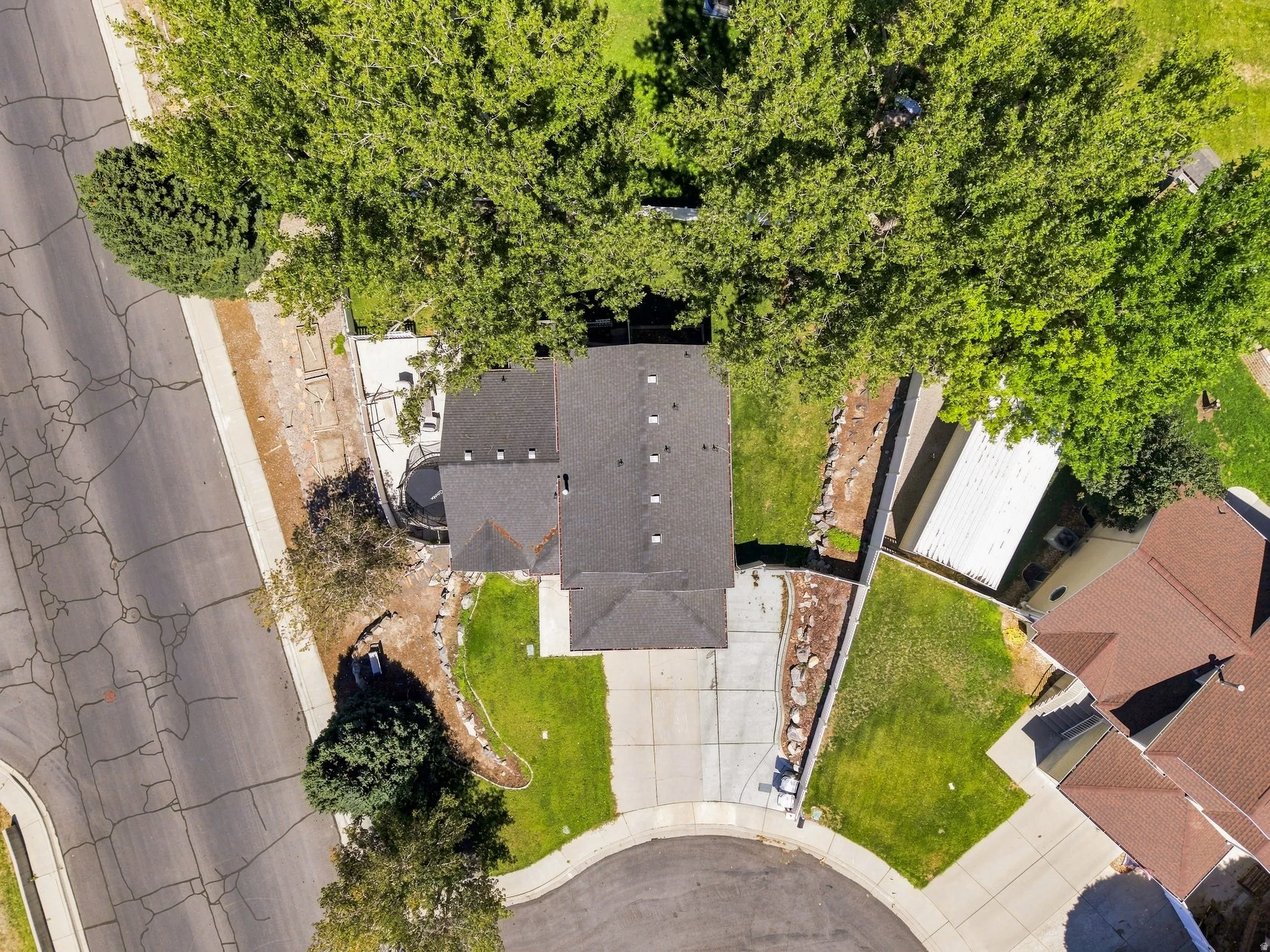 Cul-de-sac location with a concrete driveway and an attached garage