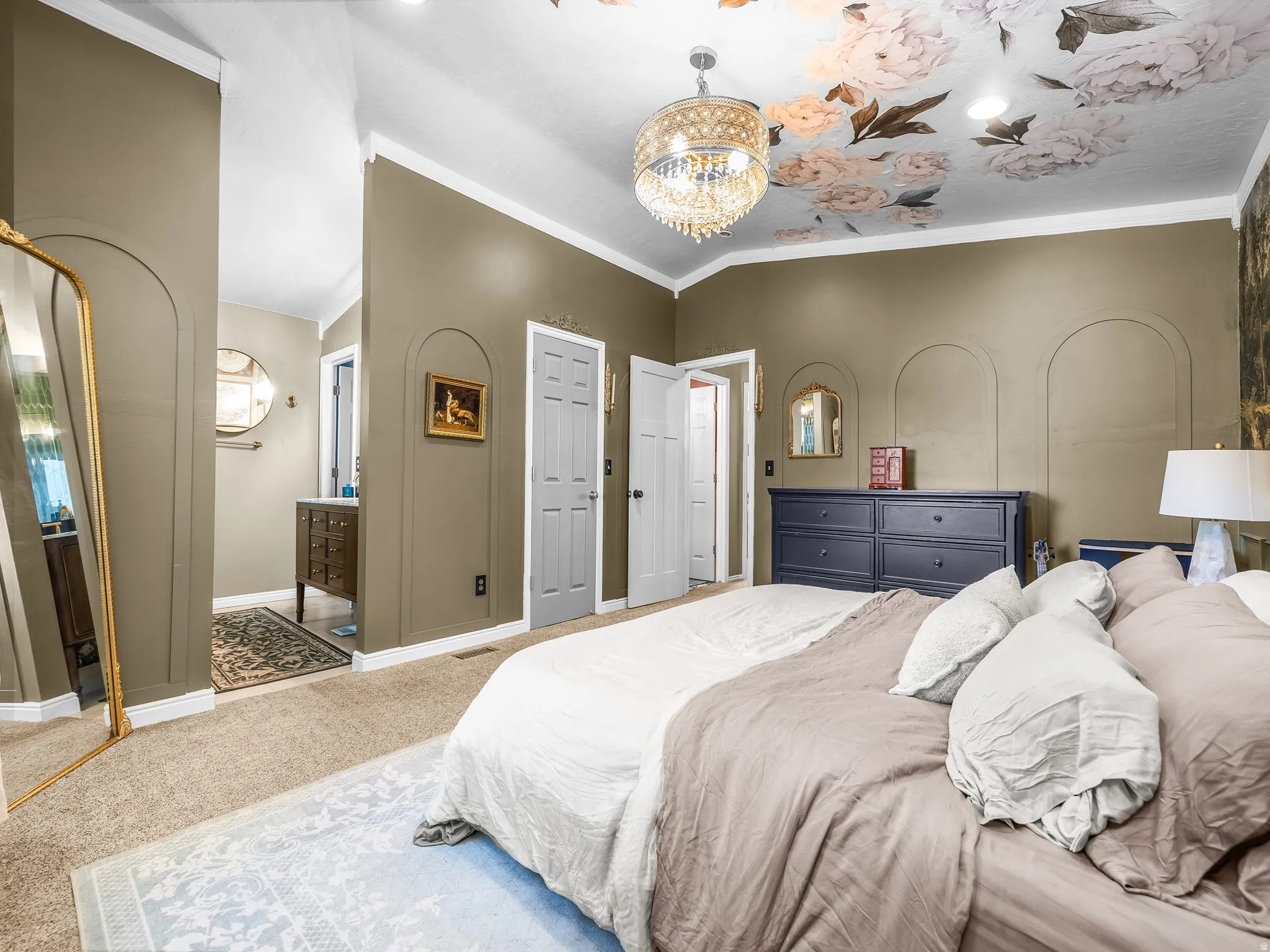 Vaulted ceiling with floral detailing and a decorative chandelier