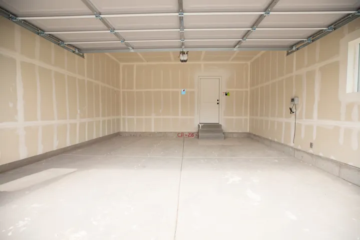 Spacious two car garage with taped finish.