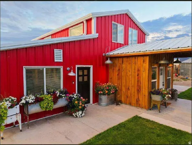 Red metal siding exterior with a white metal roof