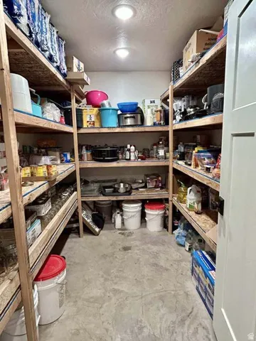 Spacious pantry with extensive wood shelving and recessed lighting
