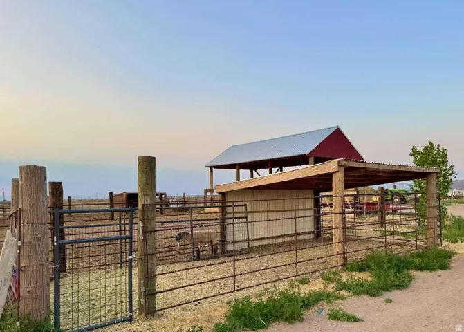Red barn structure with a silver corrugated metal roof
