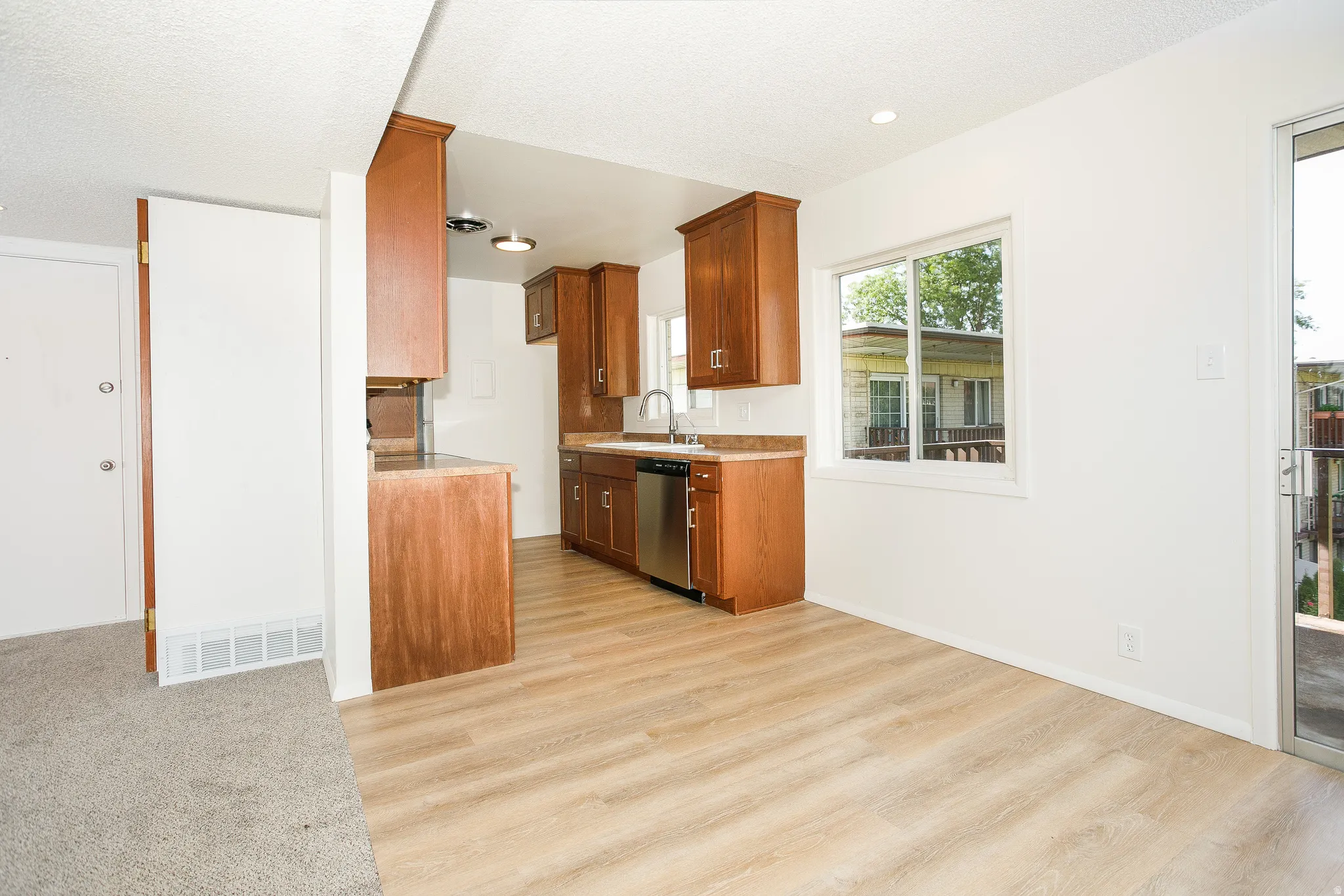 Wood-finish flooring, white walls, and a sliding glass door