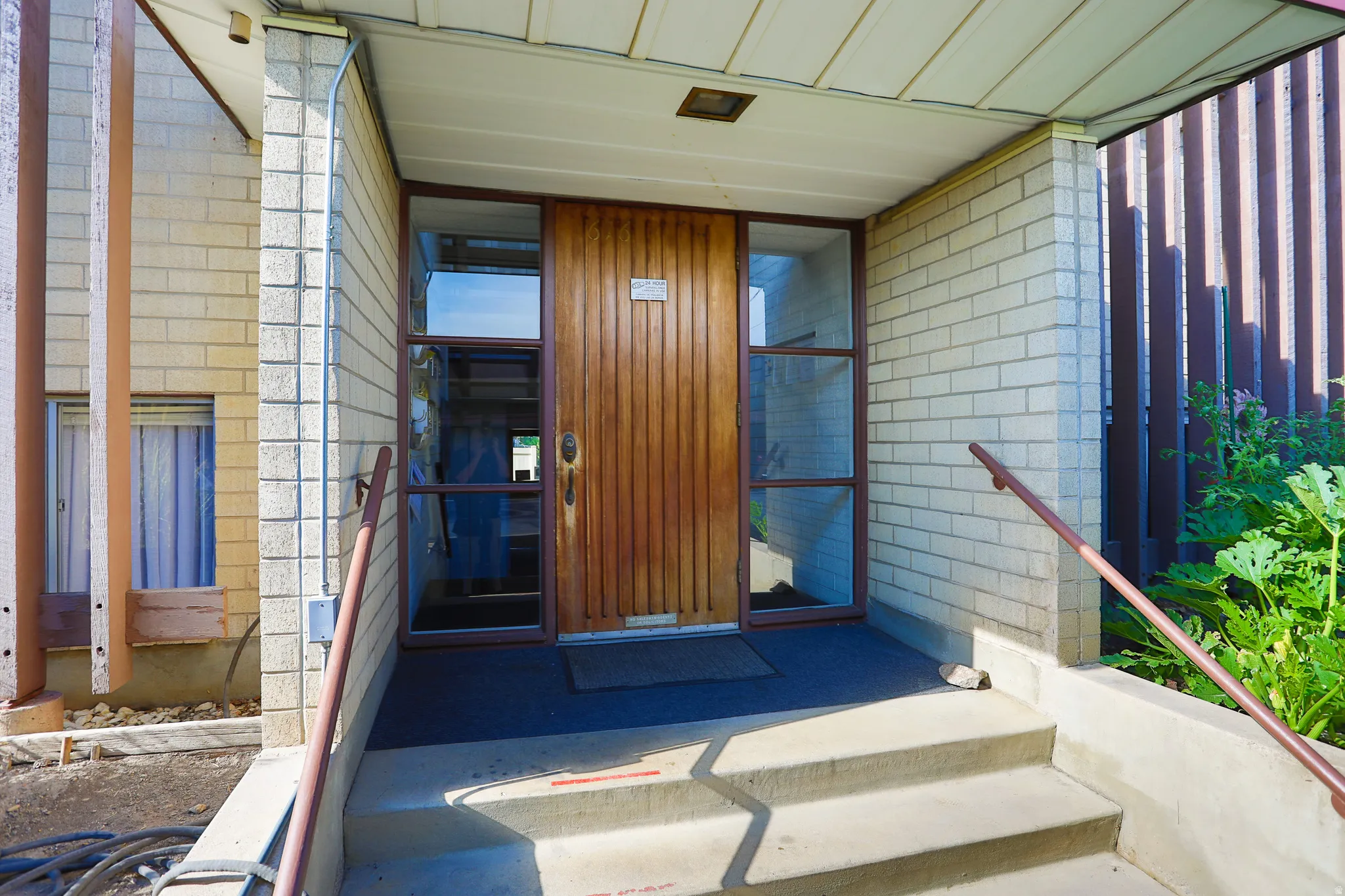 Concrete entry stairs with a metal handrail