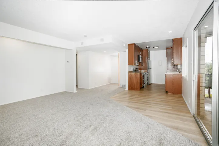 Recessed lighting, wood-finish flooring, sliding glass door, wood cabinetry, built-in stainless steel appliances