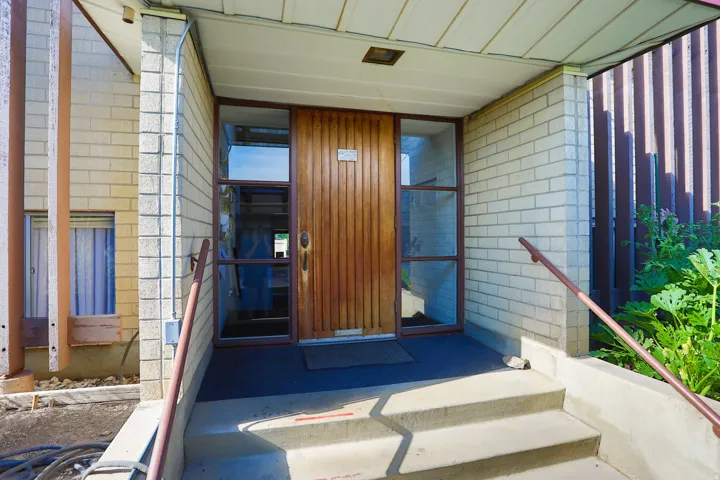 Concrete entry stairs with a metal handrail
