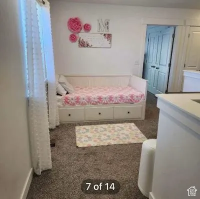 White walls, gray carpeting, and a built-in daybed with three drawers