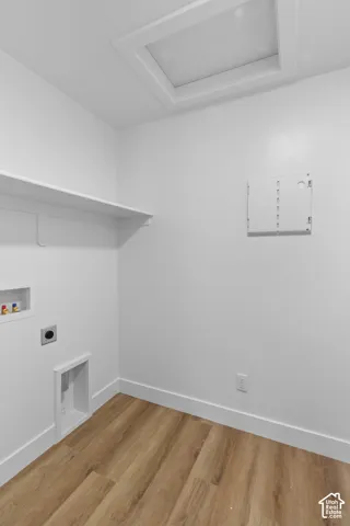 Recessed ceiling access panel, white wall shelving, wood-finish flooring, and white trim