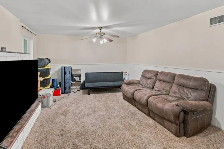 Recessed window, ceiling fan, and carpeted flooring