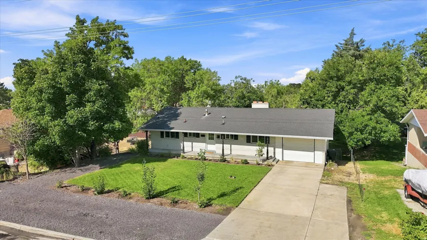Single-story residence with a dark shingle roof and a white exterior