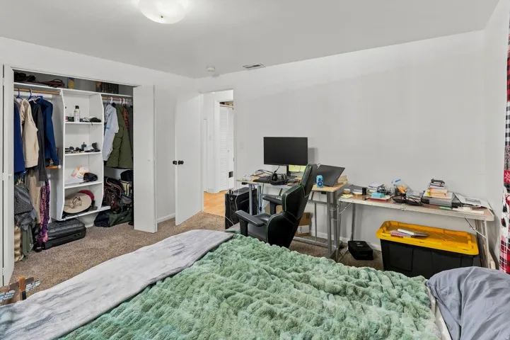 Recessed closet with bi-fold doors and integrated shelving