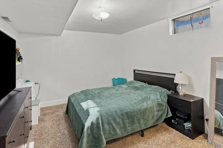 Textured carpeting, white walls, recessed window, and flush mount lighting