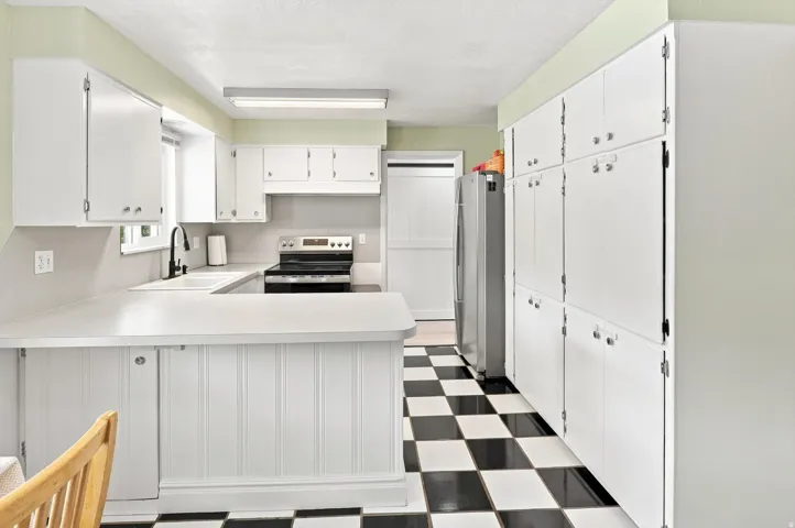 White cabinetry and checkerboard flooring