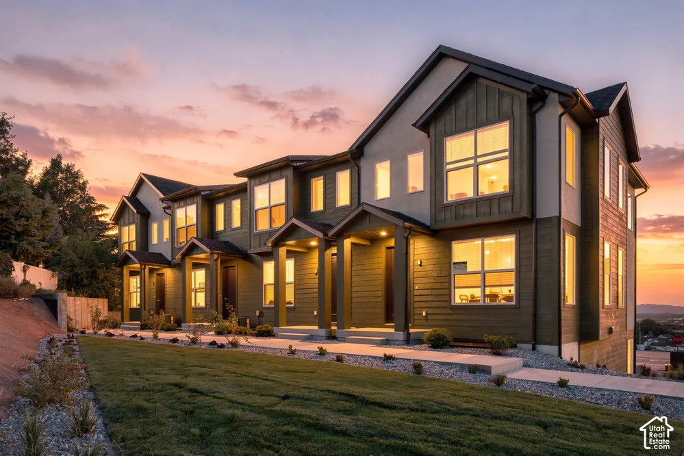 Multi-level exterior featuring horizontal siding, board-and-batten detailing, multiple gabled rooflines, covered entryways, and large picture windows