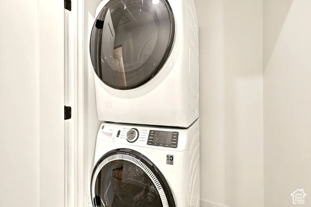 Stacked front-loading washer and dryer unit with digital control panels and glass-front doors