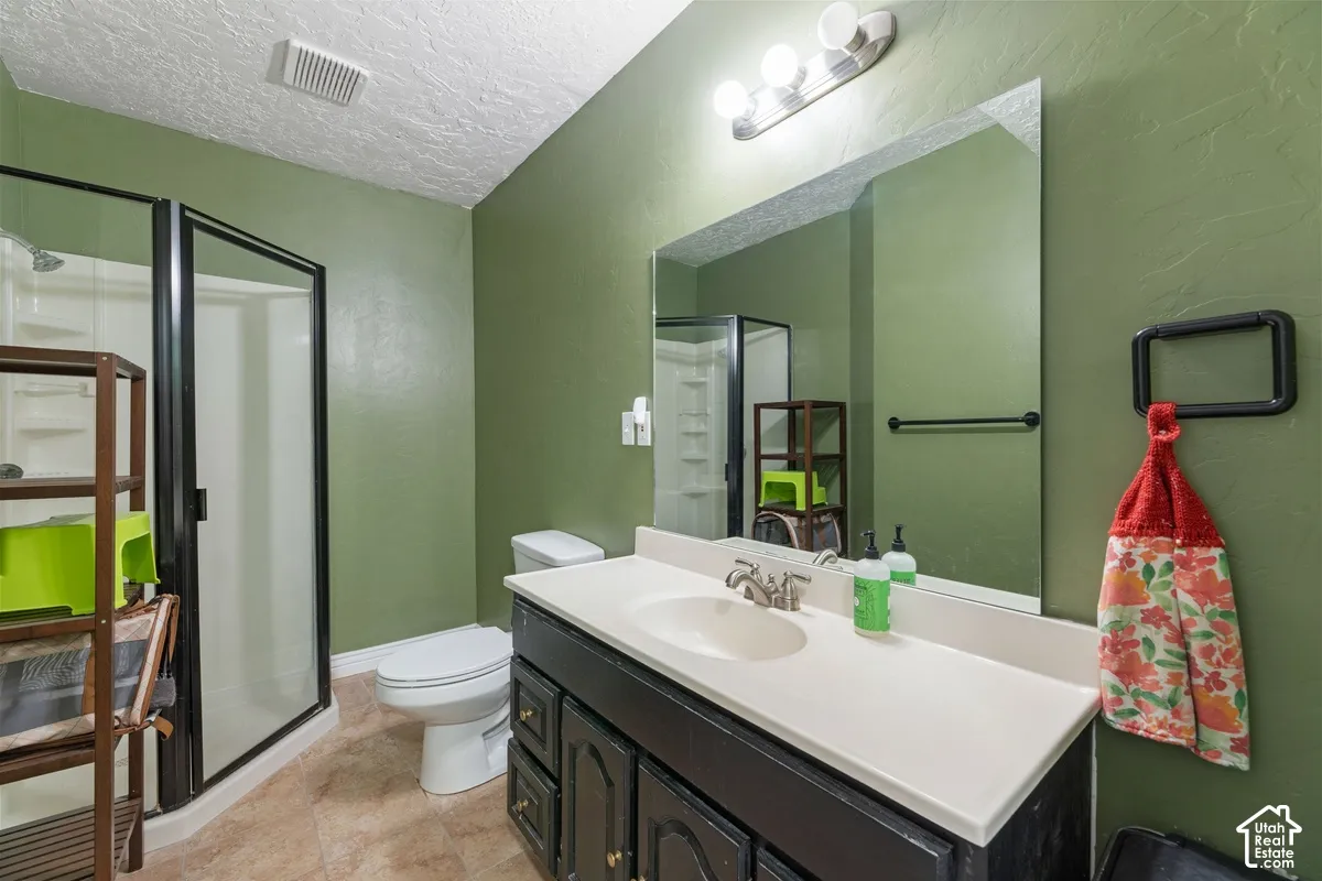 Vanity with an integrated sink, brushed nickel faucet, and a large mirror