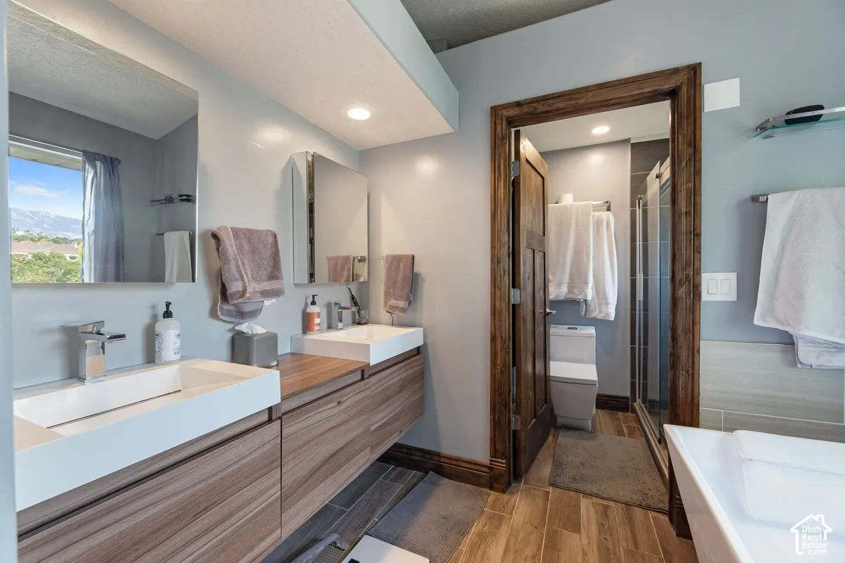 Dual floating vanities with integrated rectangular sinks, modern chrome faucets, and wood-finish cabinetry