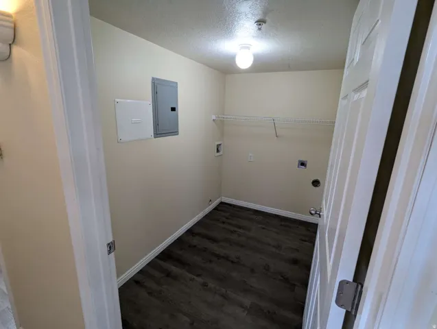 Wood-finish flooring with white trim and a wire storage shelf