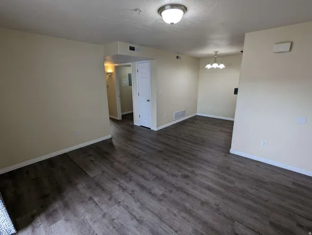 Wood-finish flooring throughout, light neutral wall tones, and white trim