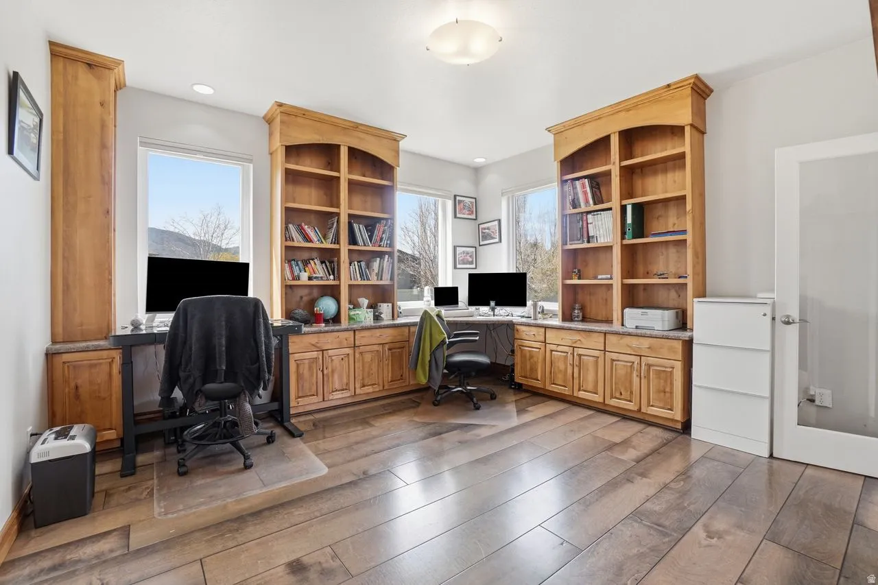 Wood-finish flooring throughout, complemented by built-in wood cabinetry and shelving