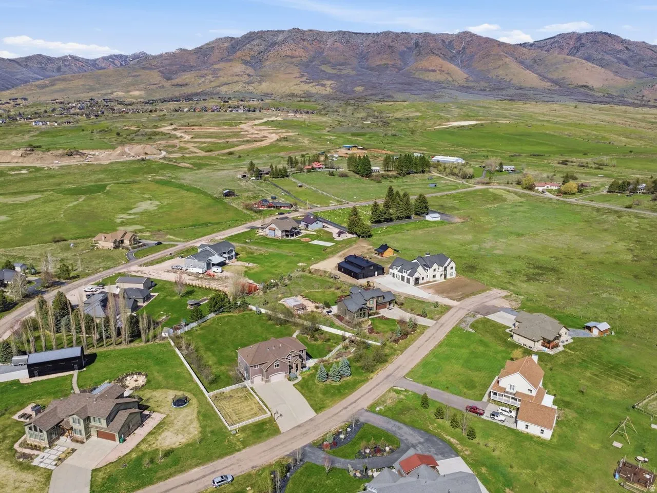 Expansive mountainous landscape with scattered residential properties