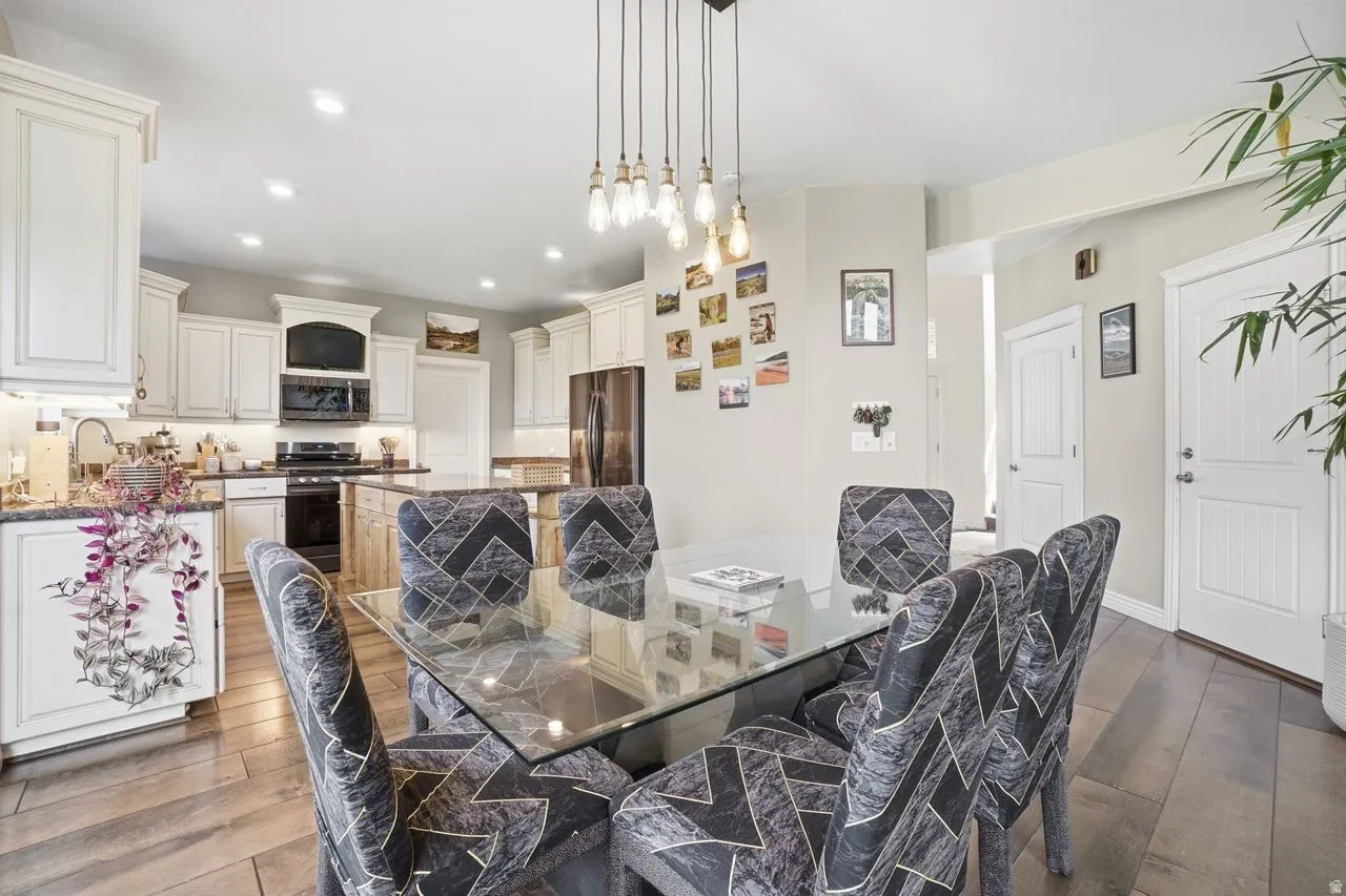 Kitchen with white cabinetry, dark countertops, and stainless steel appliances
