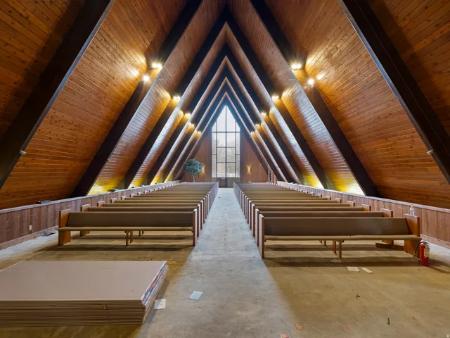Vaulted wood-paneled ceilings with exposed beams and recessed lighting