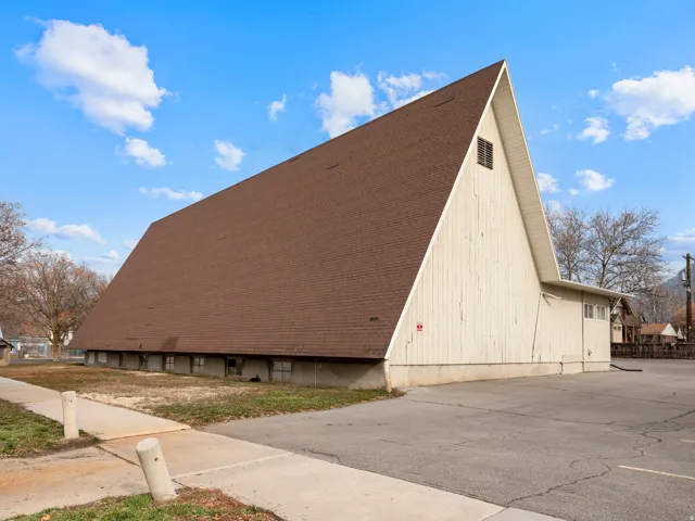 Asymmetrical gable roofline and a multi-level wood-clad exterior