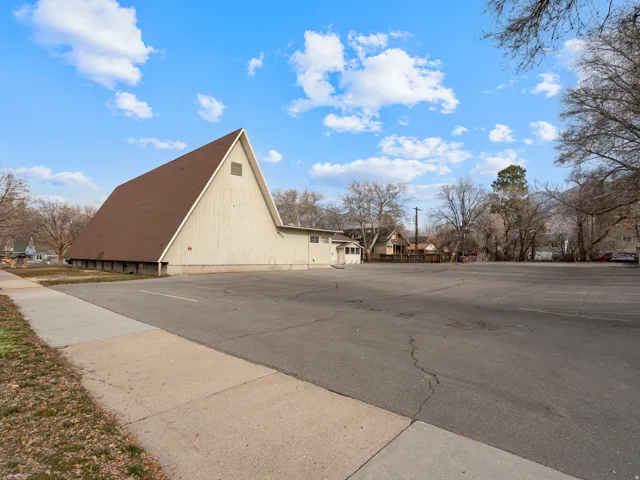 A-frame architectural style with a prominent brown roof and light-colored siding