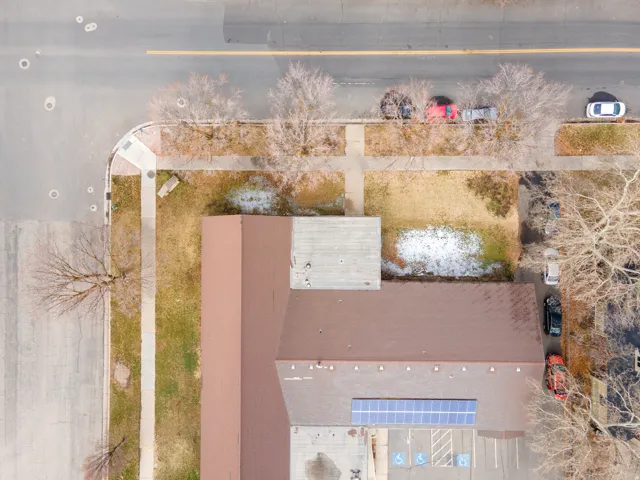 Building with a brown roof and solar panels