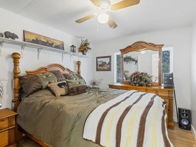 Wood-finish flooring, ceiling fan, and window