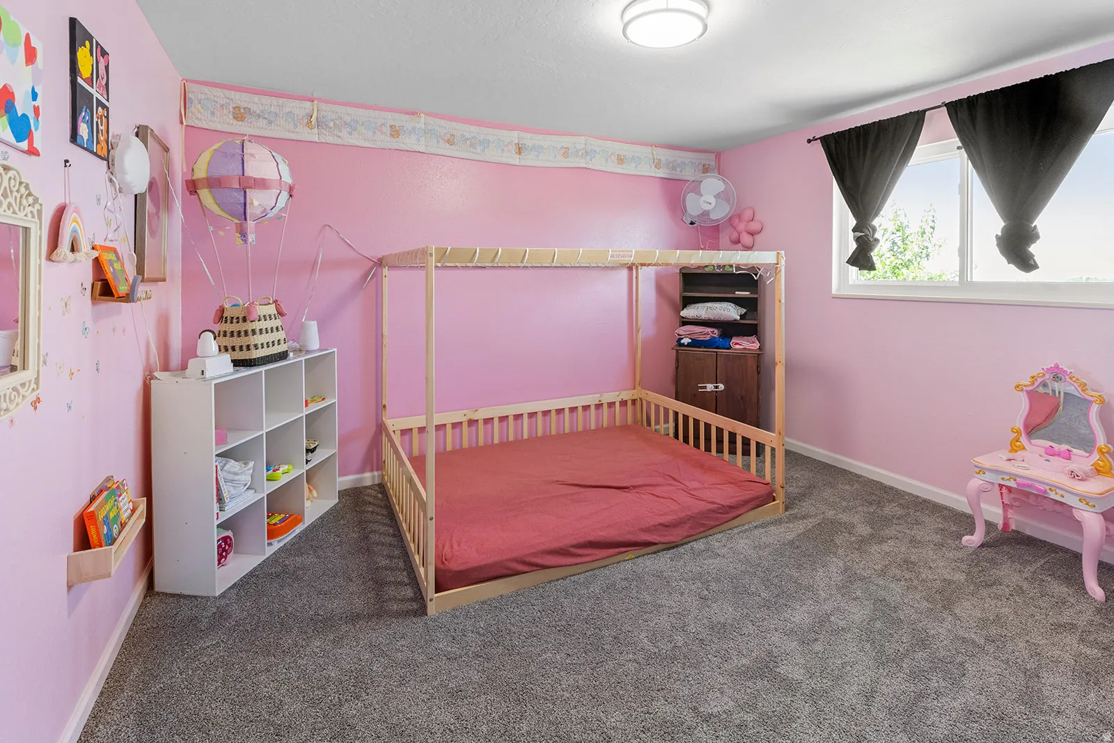 Recessed lighting, wood-finish flooring, and a window with white trim