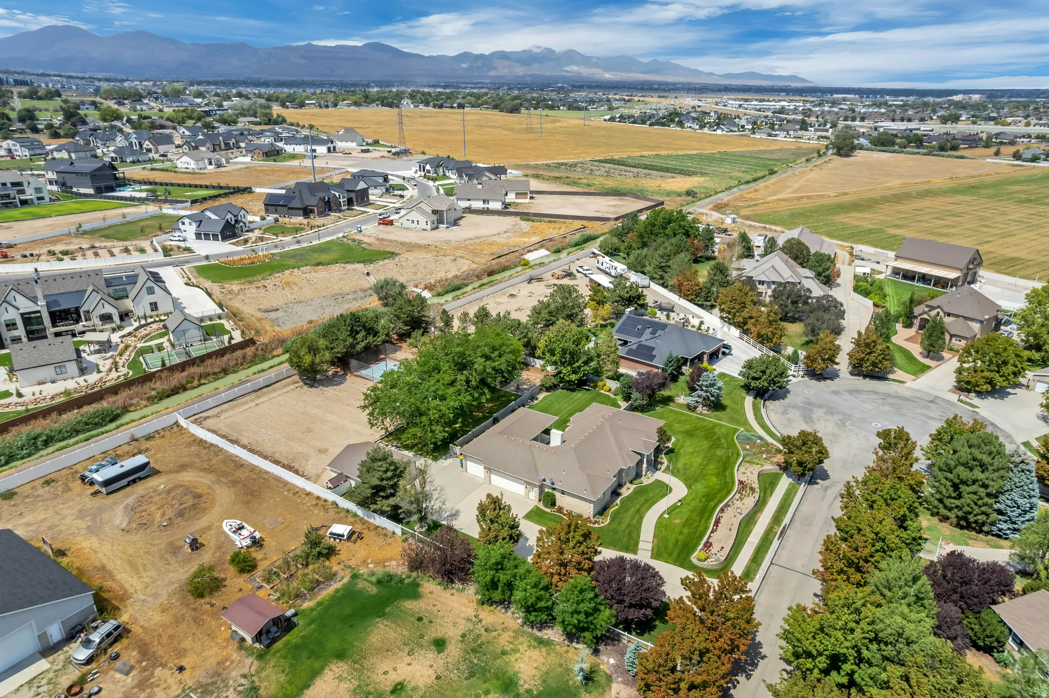 Expansive residential area featuring established homes, undeveloped lots, and mountain scenery
