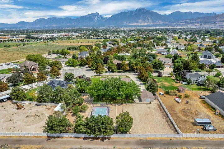Expansive lot with mature trees, a dedicated sports court, and mountain backdrop
