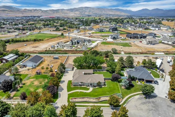 Expansive property with a paved driveway, mature trees, and established landscaping