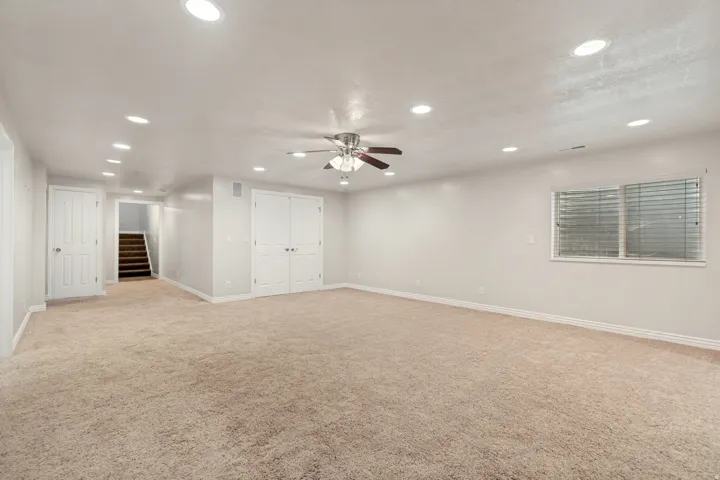 Spacious room with recessed lighting, ceiling fan, and carpeted flooring