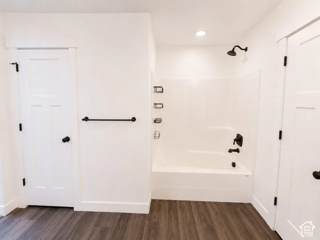 White tub/shower combination with matte black fixtures