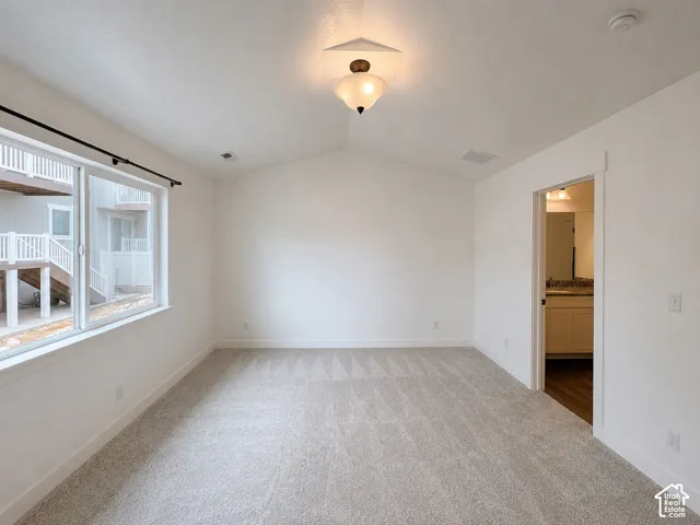Vaulted ceiling featuring a flush-mount light fixture