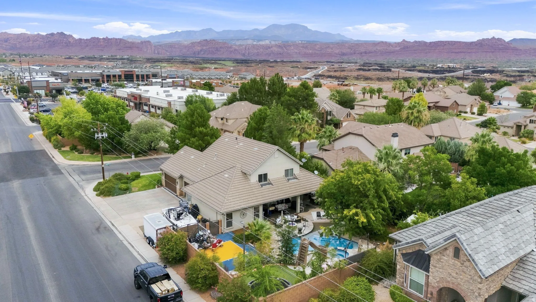 Expansive property featuring a multi-level roofline, a private swimming pool, and a covered patio