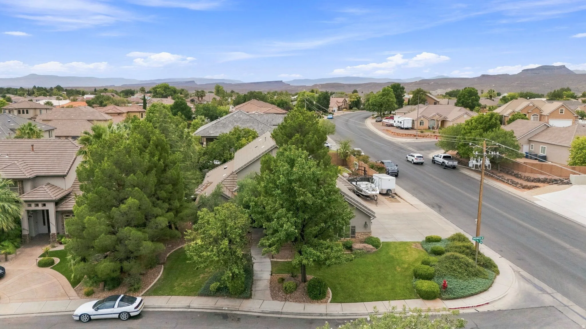 Expansive neighborhood featuring residential properties with pitched roofs, mature trees, and landscaping