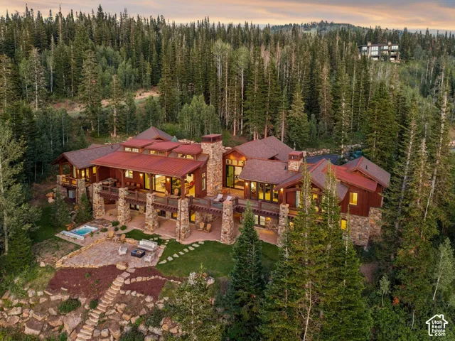 Expansive stone and wood exterior with multiple balconies and a red metal roof