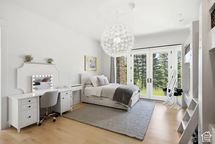 Light wood-finish flooring, white walls, and a contemporary ceiling fixture complement the room's bright aesthetic