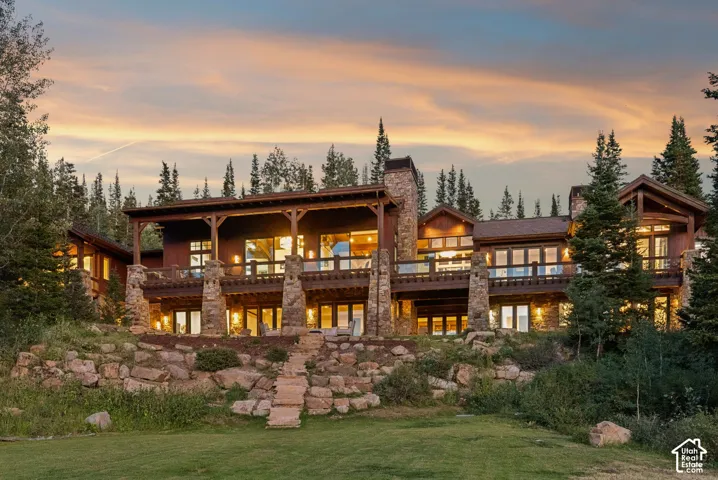 Stone and wood-clad exterior with multiple balconies and a covered deck