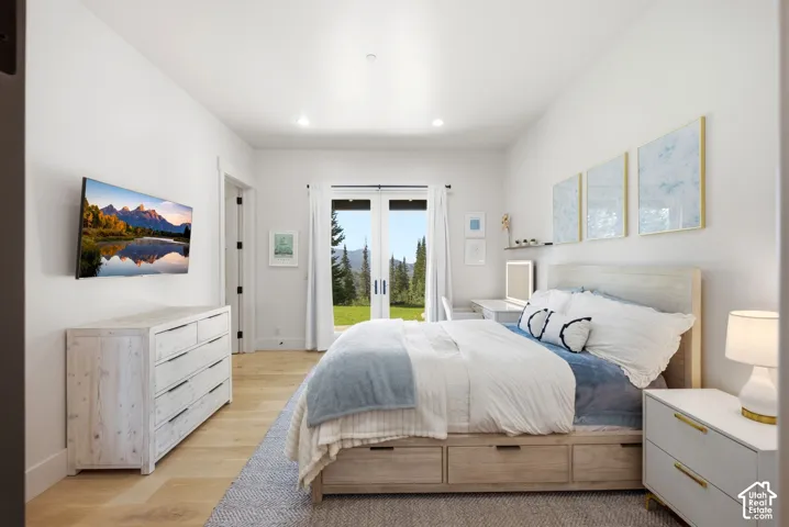 Recessed lighting illuminates wood-finish flooring