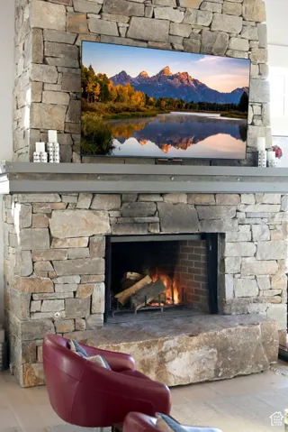 Stacked stone fireplace surround with a large, rough-hewn stone hearth