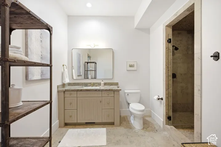 Vanity with a light-toned countertop, rectangular mirror, and integrated lighting