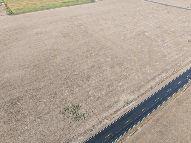 Expansive open land parcel with direct paved road frontage