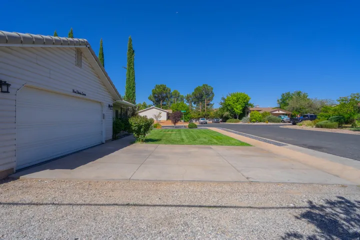 White horizontal siding exterior with an attached garage and concrete driveway