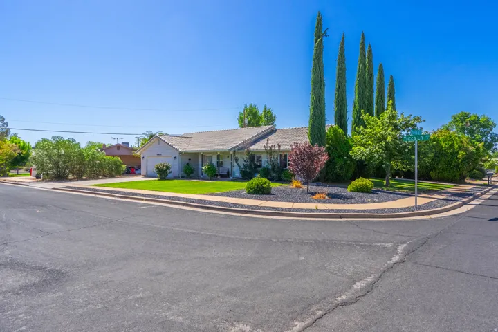 Single-story residence with an attached garage, featuring a shingle roof and a paved driveway